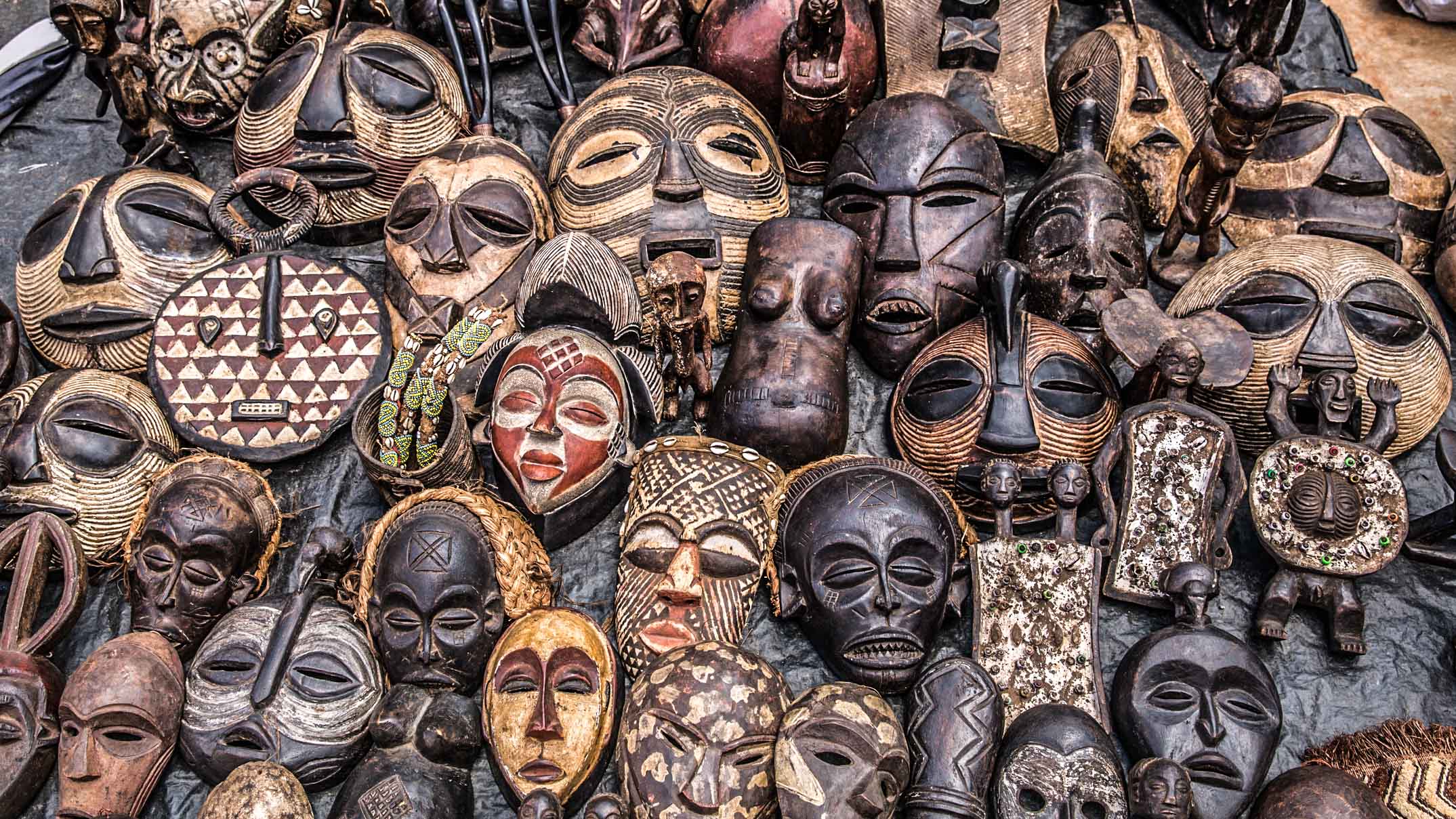 Collection of wooden masks from the Masai market in Nairobi, Kenya
